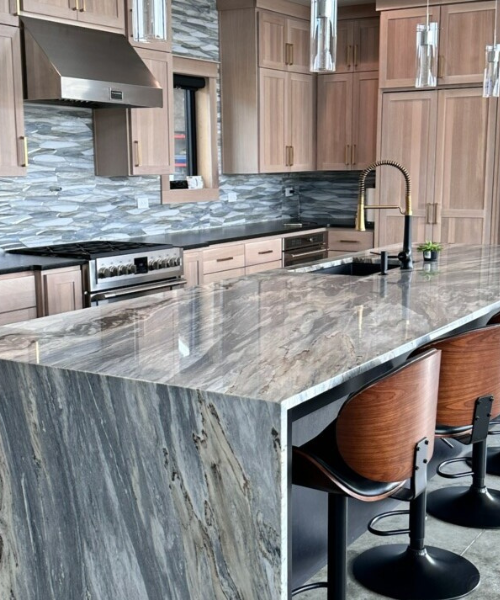 A beautiful Stella Marble island countertop with a mitered waterfall edge. Click this image for a link to our Residential page.